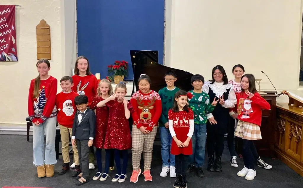 Students in winter jumpers at a recital
